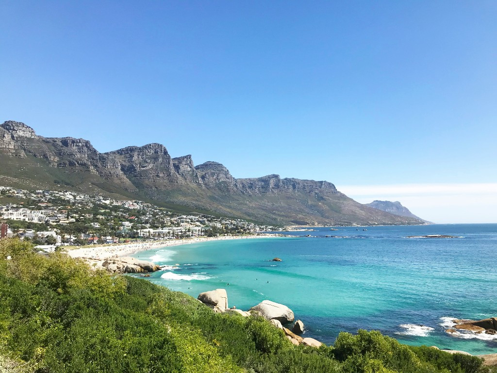 Camps Bay coastline in Cape Town with turquoise water, white sand, and the Twelve Apostles mountains